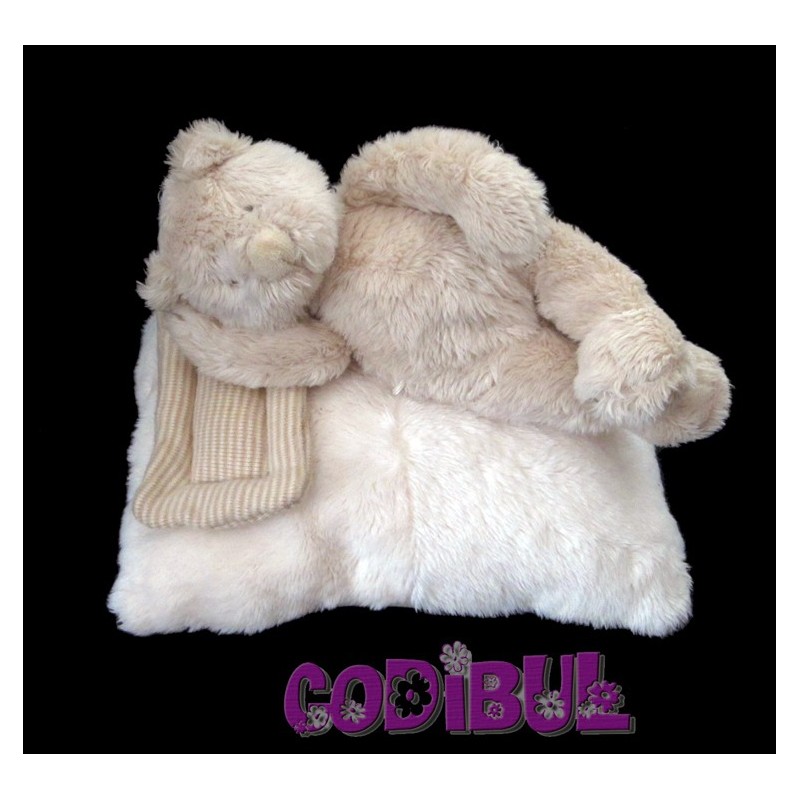 MOULIN ROTY Doudou musical ours allongé sur coussin linvosges